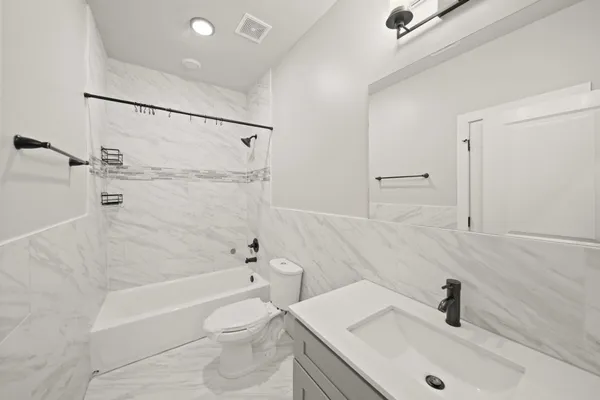 a bathroom with a sink a toilet and a tub