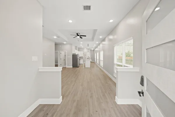 a view of kitchen and hall with wooden floor