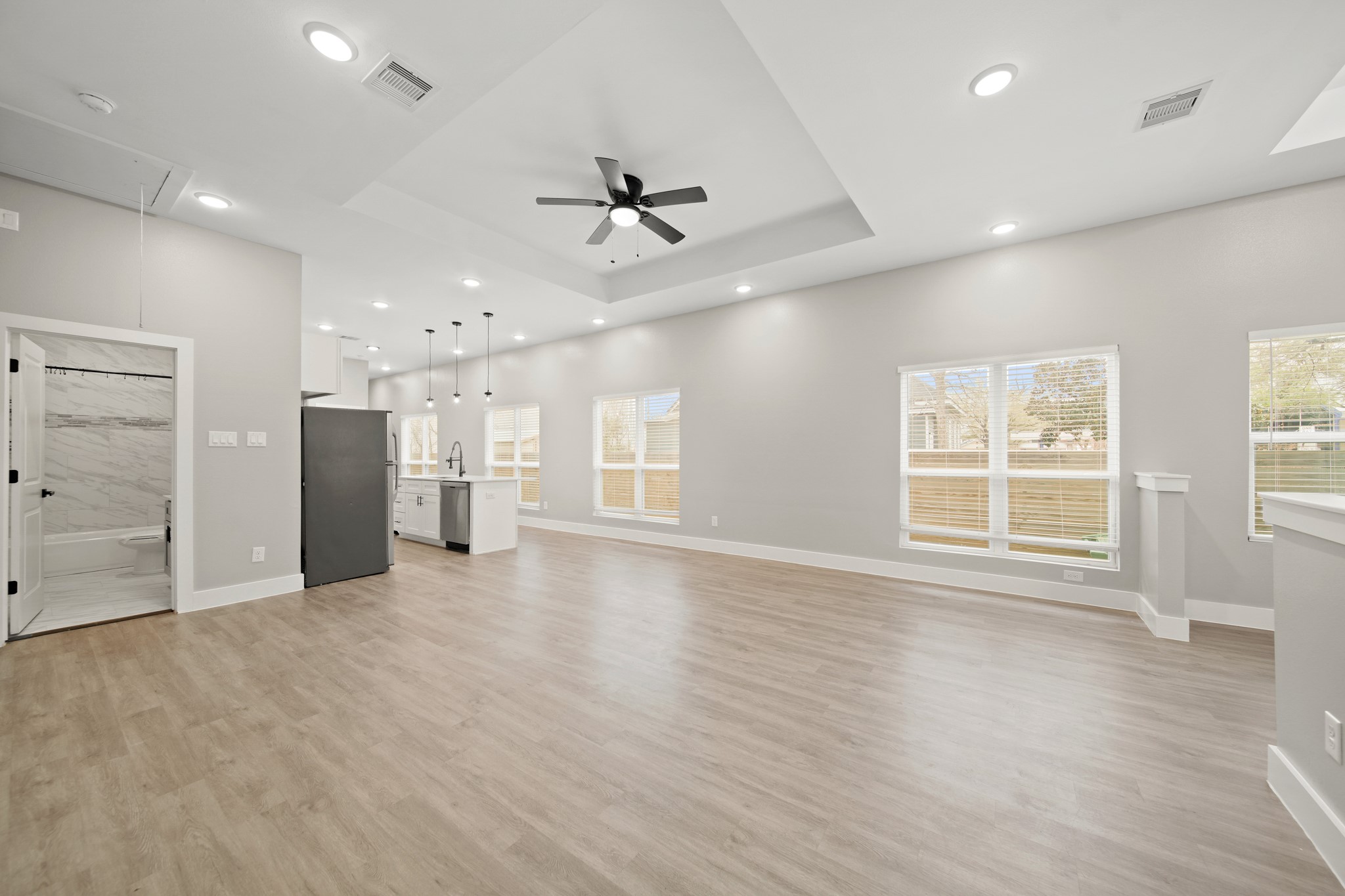 507 Carl Street Houston, TX 77009 - Photo 6 of 25 a view of an empty room with a window and wooden floor