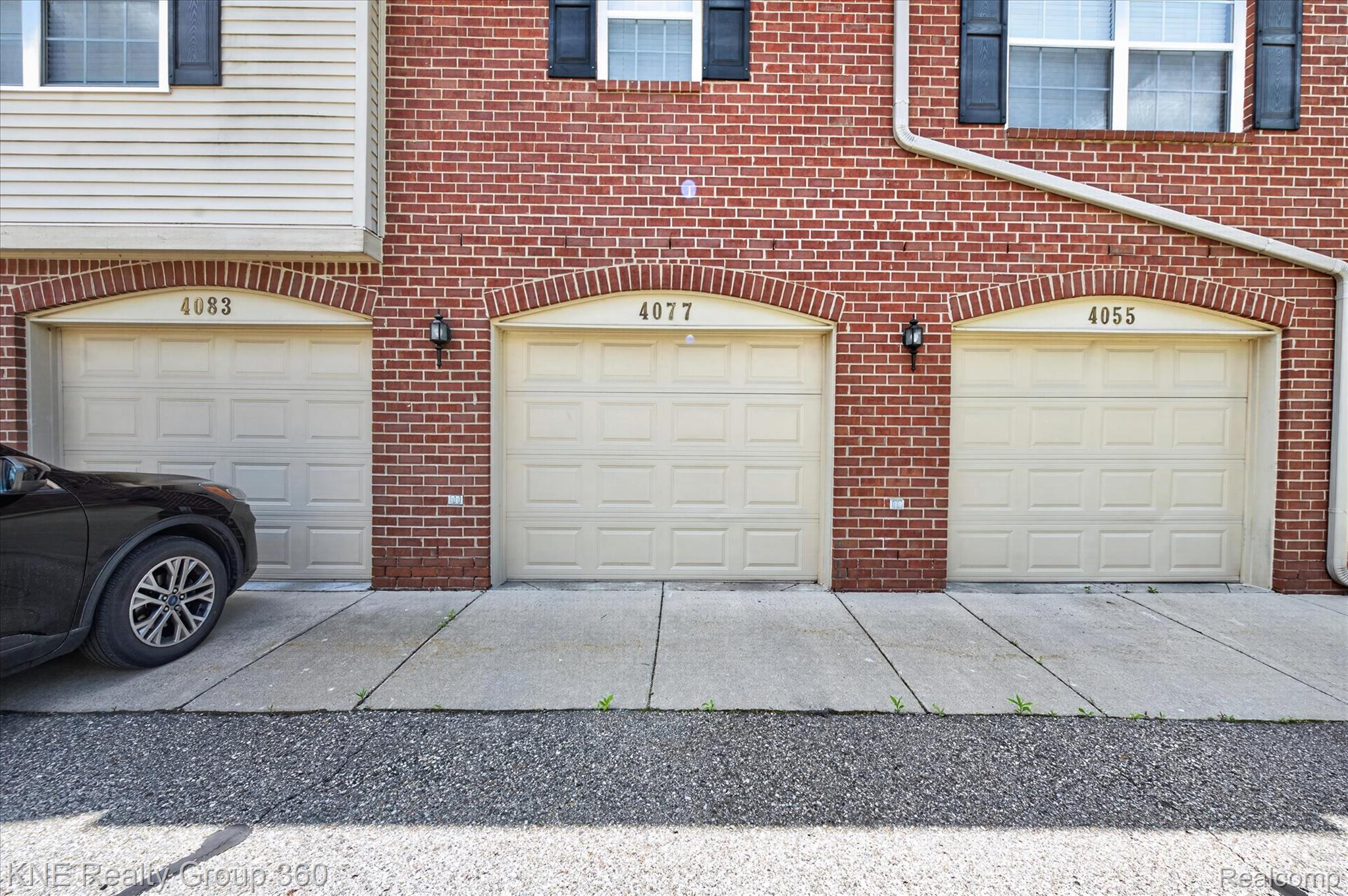 4077 Berkeley Avenue Canton, MI 48188 - Photo 29 of 32 Brick facade featuring three arched garage doors
