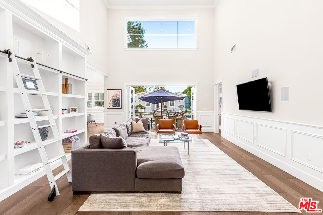 17524 Jayden Lane Encino, CA 91316 - Photo 16 of 52 a living room with furniture and a flat screen tv