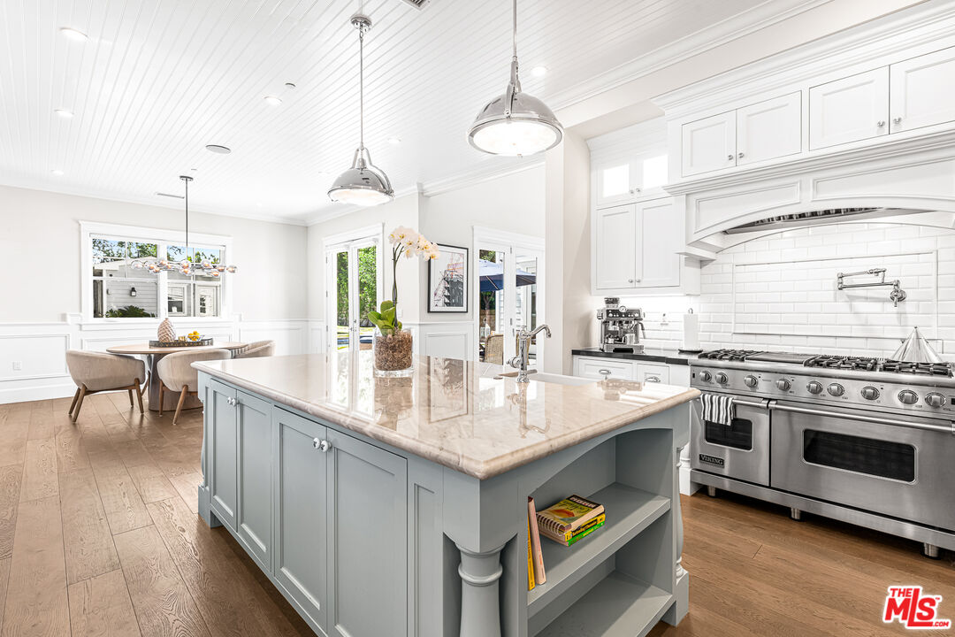 17524 Jayden Lane Encino, CA 91316 - Photo 22 of 52 a kitchen with stainless steel appliances granite countertop a sink a stove and a wooden floors
