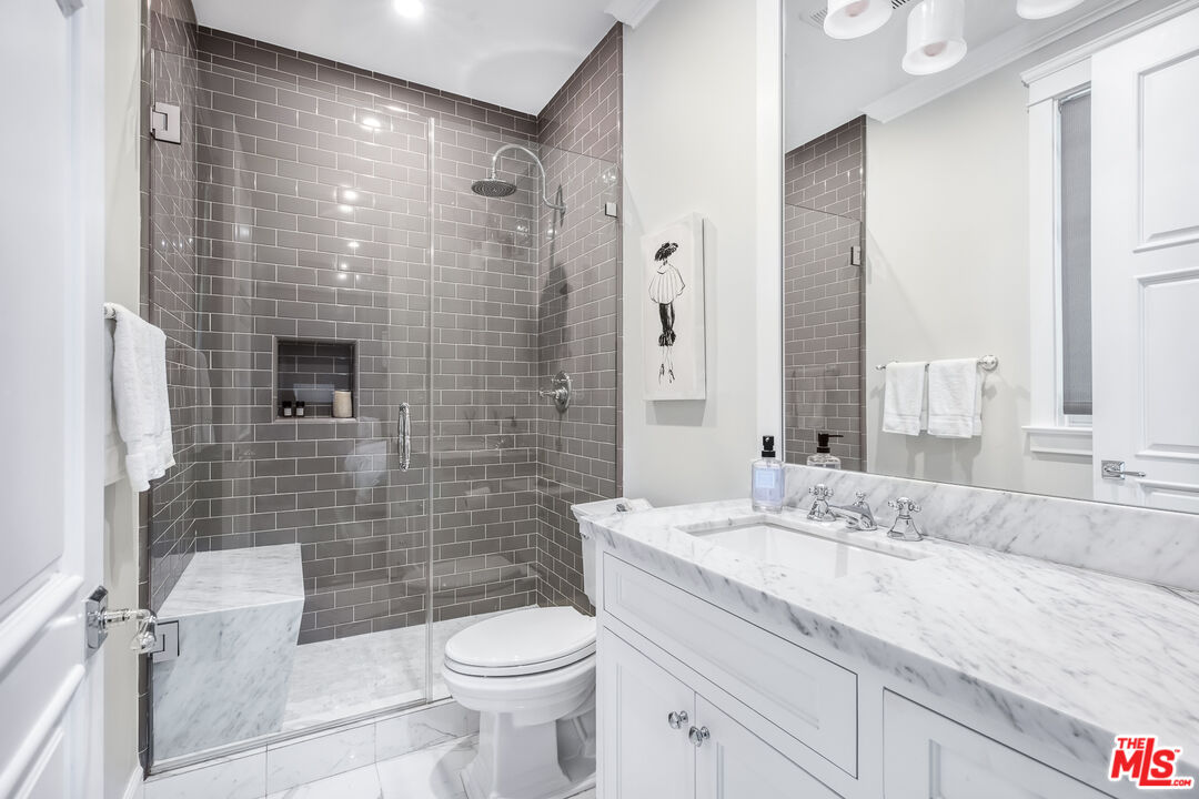 17524 Jayden Lane Encino, CA 91316 - Photo 26 of 52 a bathroom with a granite countertop sink toilet and shower