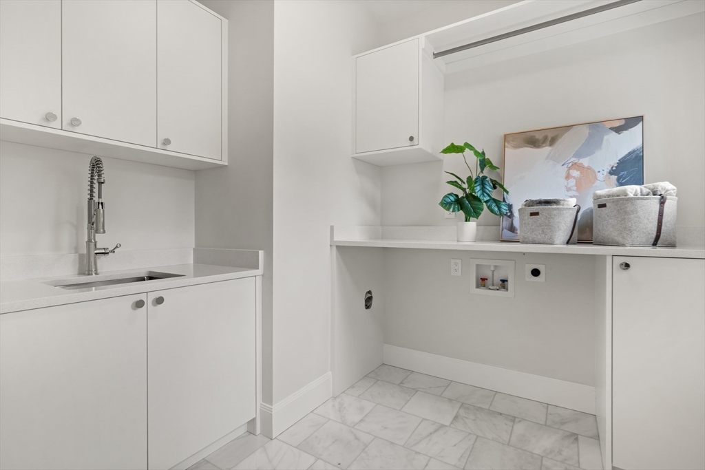 22 Priscilla Circle Wellesley, MA 02481 - Photo 24 of 38 a kitchen with white cabinets and white appliances