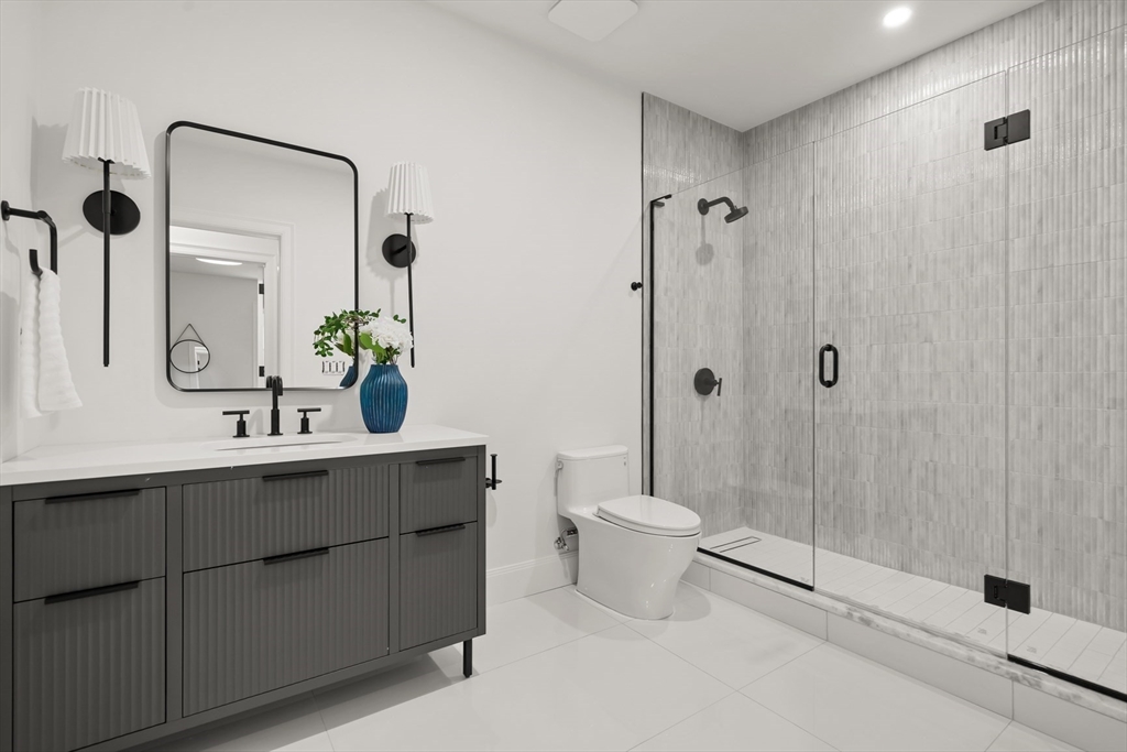 22 Priscilla Circle Wellesley, MA 02481 - Photo 34 of 38 a bathroom with a granite countertop sink a toilet and shower