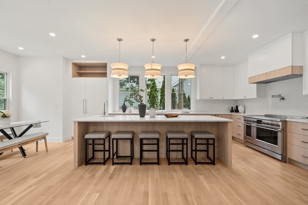 22 Priscilla Circle Wellesley, MA 02481 - Photo 6 of 38 a large kitchen with a table and chairs in it