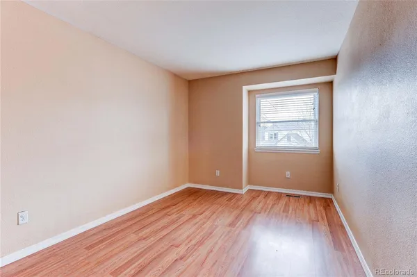 a view of a room with wooden floor