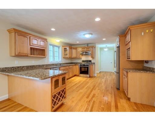 24 Regency Drive Dracut, MA 01826 - Photo 11 of 42 a kitchen with stainless steel appliances granite countertop a refrigerator a stove and a sink