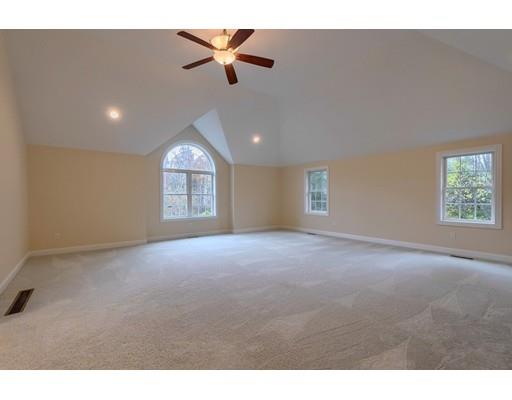 24 Regency Drive Dracut, MA 01826 - Photo 16 of 42 a view of a big room with windows and chandelier fan