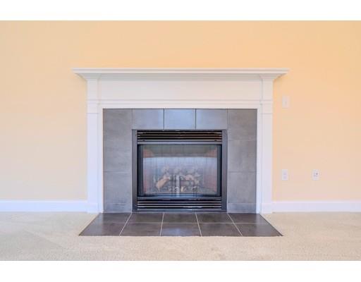 24 Regency Drive Dracut, MA 01826 - Photo 18 of 42 a living room with a fireplace