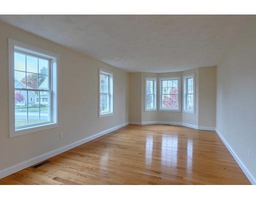 24 Regency Drive Dracut, MA 01826 - Photo 19 of 42 a view of an empty room with wooden floor and windows