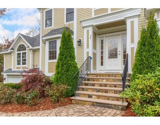24 Regency Drive Dracut, MA 01826 - Photo 2 of 42 a front view of a house with a garden