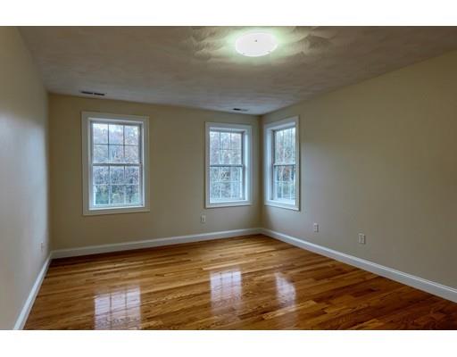24 Regency Drive Dracut, MA 01826 - Photo 24 of 42 a view of an empty room with wooden floor and a window