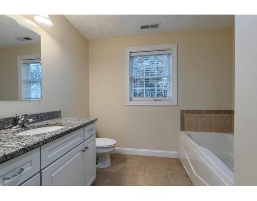 24 Regency Drive Dracut, MA 01826 - Photo 25 of 42 a bathroom with a granite countertop sink a toilet and bathtub