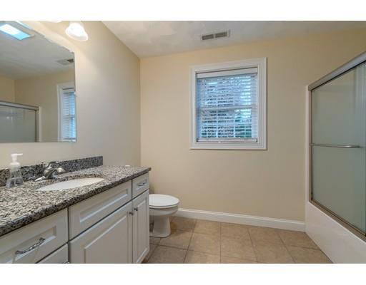 24 Regency Drive Dracut, MA 01826 - Photo 29 of 42 a bathroom with a granite countertop sink toilet a mirror and a window