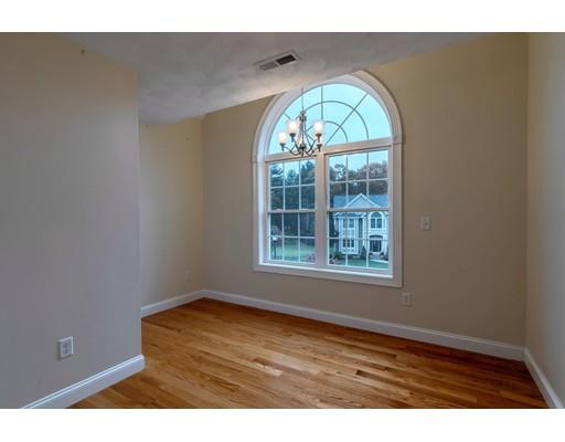24 Regency Drive Dracut, MA 01826 - Photo 30 of 42 a view of an empty room with wooden floor and a window