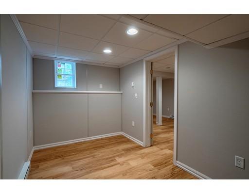 24 Regency Drive Dracut, MA 01826 - Photo 36 of 42 a view of an empty room with wooden floor