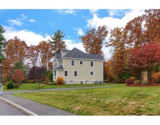 24 Regency Drive Dracut, MA 01826 - Photo 37 of 42 a front view of a house with garden