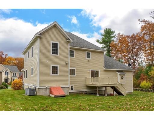 24 Regency Drive Dracut, MA 01826 - Photo 38 of 42 a front view of a house with a yard