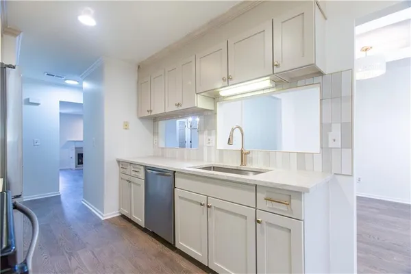 a kitchen with stainless steel appliances granite countertop a sink a stove and a refrigerator
