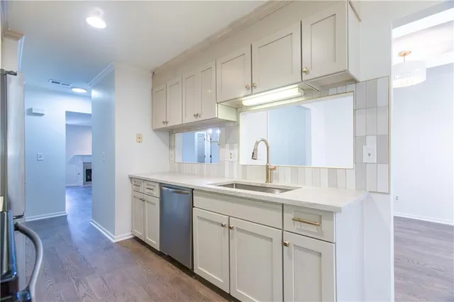 a kitchen with stainless steel appliances granite countertop a sink a stove and a refrigerator