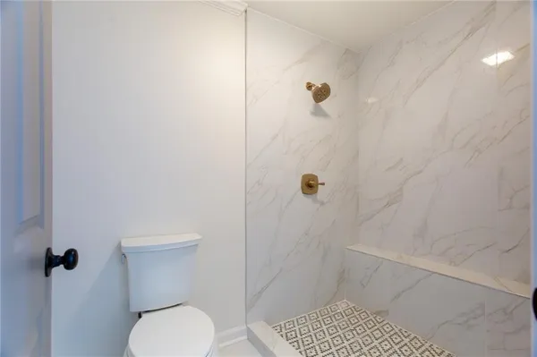 a bathroom with a toilet and shower