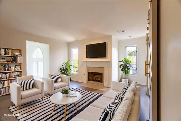 a living room with furniture a fireplace and a flat screen tv