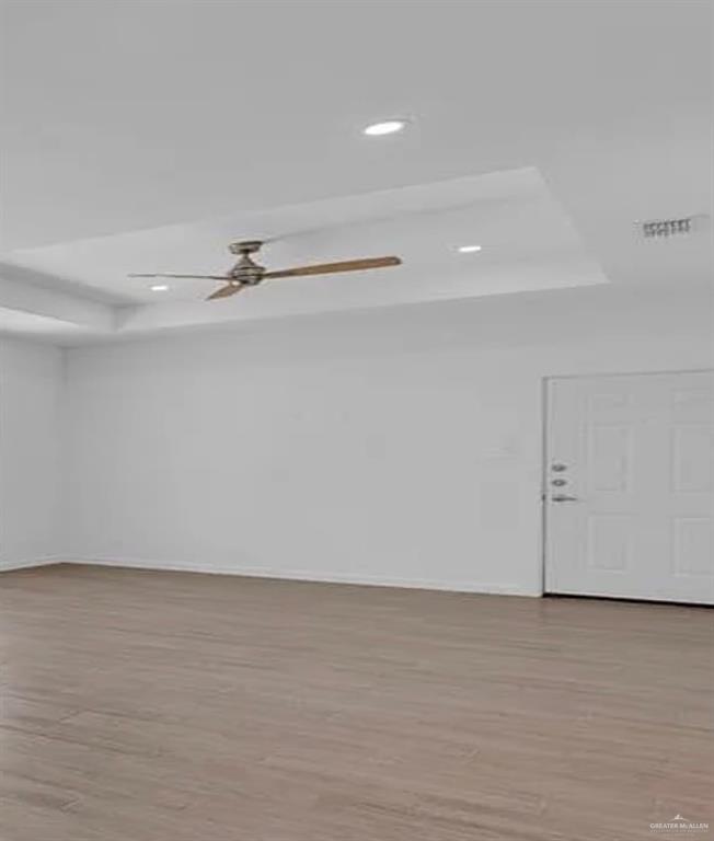 1403 Marcela Drive, Unit 3 Weslaco, TX 78599 - Photo 5 of 13 Spare room with a raised ceiling, light wood-type flooring, a ceiling fan, and recessed lighting
