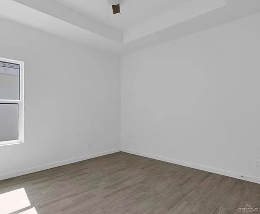 1403 Marcela Drive, Unit 3 Weslaco, TX 78599 - Photo 8 of 13 Empty room with a raised ceiling, wood finished floors, and a ceiling fan