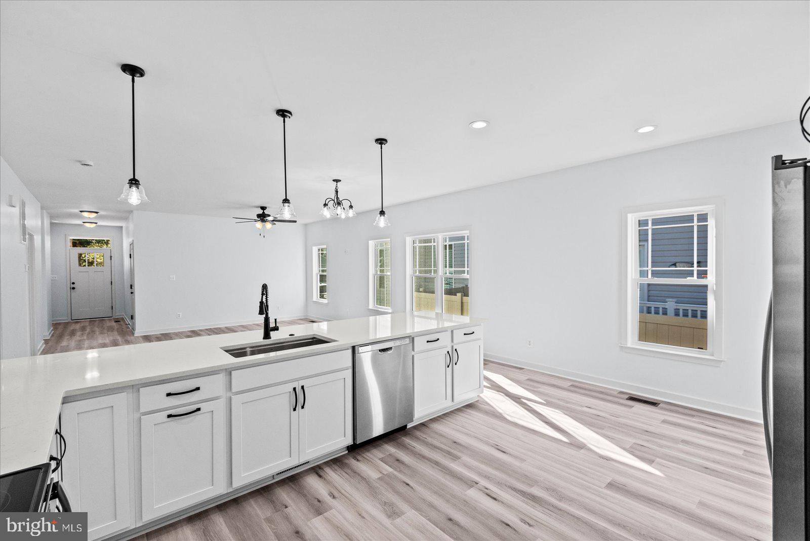 133 6th Street Colonial Beach, VA 22443 - Photo 18 of 34 a view of a kitchen counter space a sink wooden floor and windows