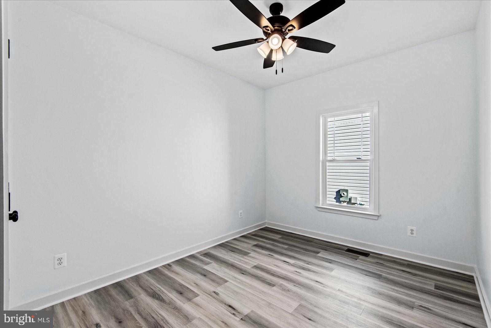 133 6th Street Colonial Beach, VA 22443 - Photo 24 of 34 an empty room with a window and a fan