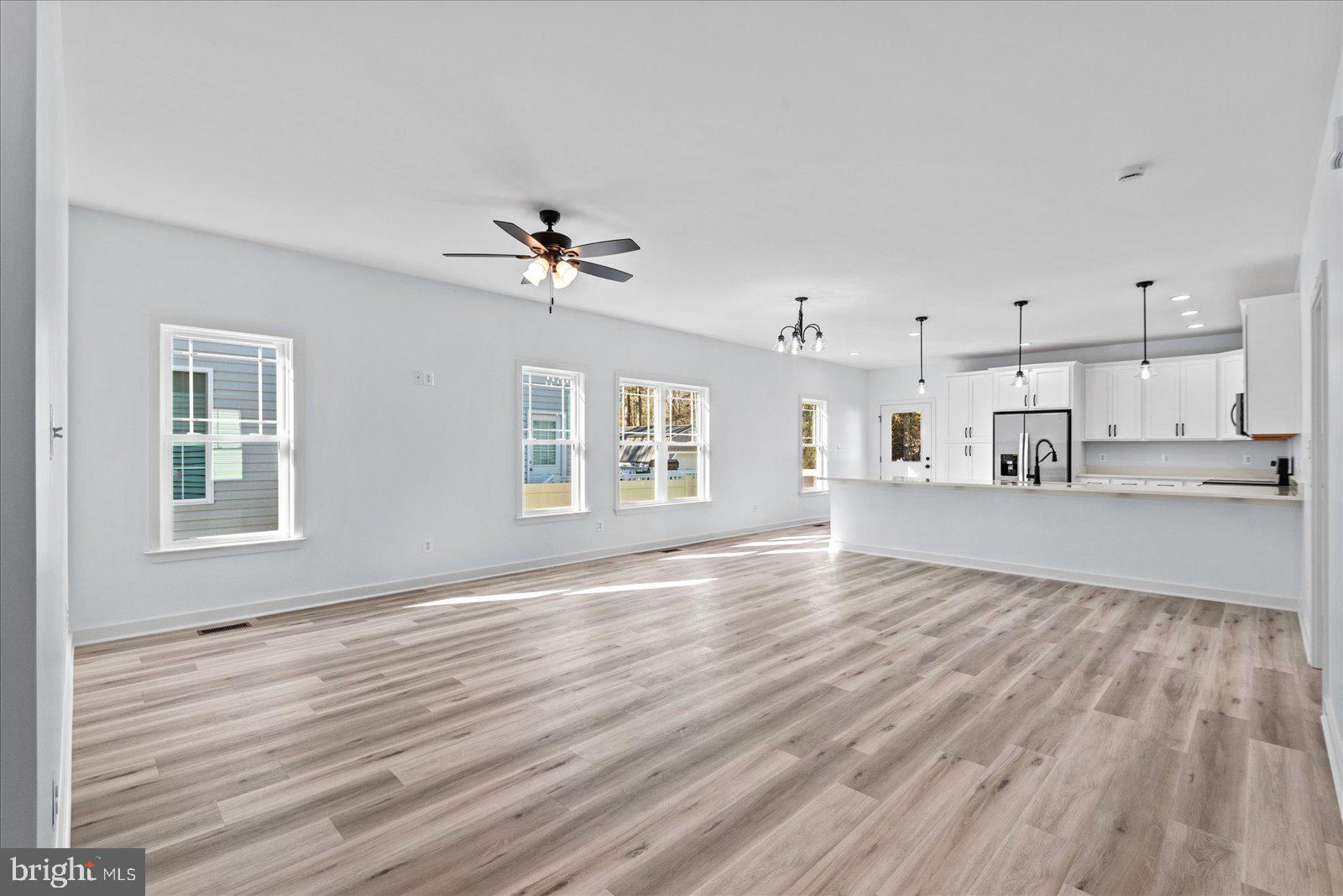 133 6th Street Colonial Beach, VA 22443 - Photo 8 of 34 a view of an empty room with a window and wooden floor