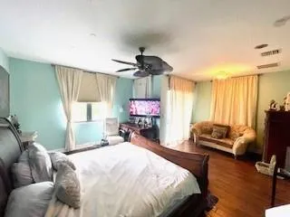 a spacious bathroom with a double vanity sink large mirror and a bathtub