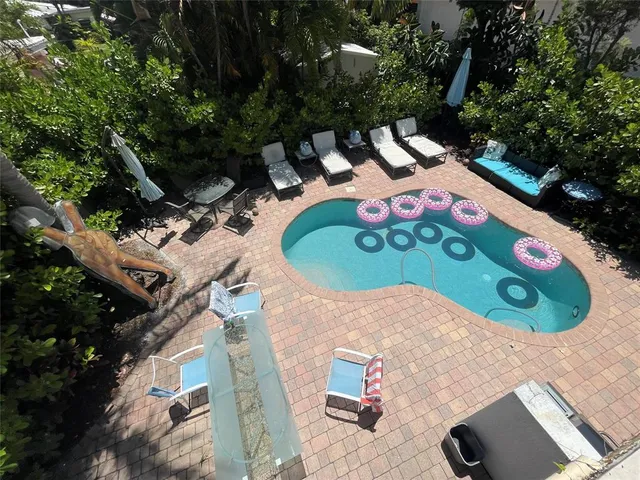 a view of a swimming pool with an outdoor space and deck area