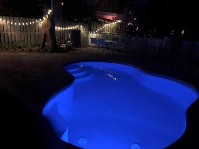 a living room with large couches chandelier and a large window