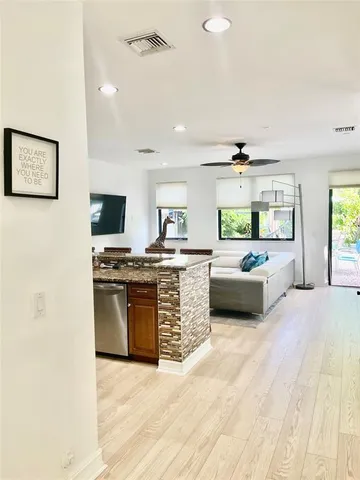 a large kitchen with a table and chairs