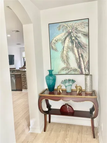 a kitchen with stainless steel appliances kitchen island granite countertop a stove top oven a sink a dining table and chairs