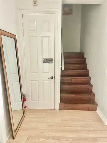 a kitchen with a stove a sink a counter top space and living room view