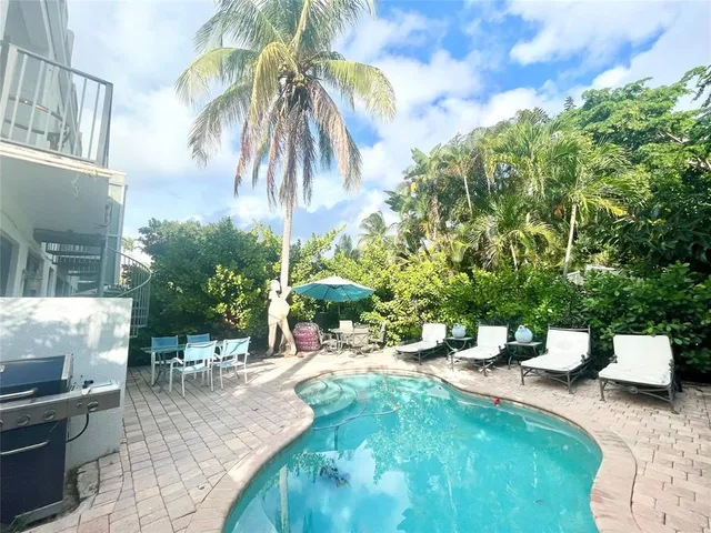 a spacious bathroom with a double vanity sink large mirror and a bathtub