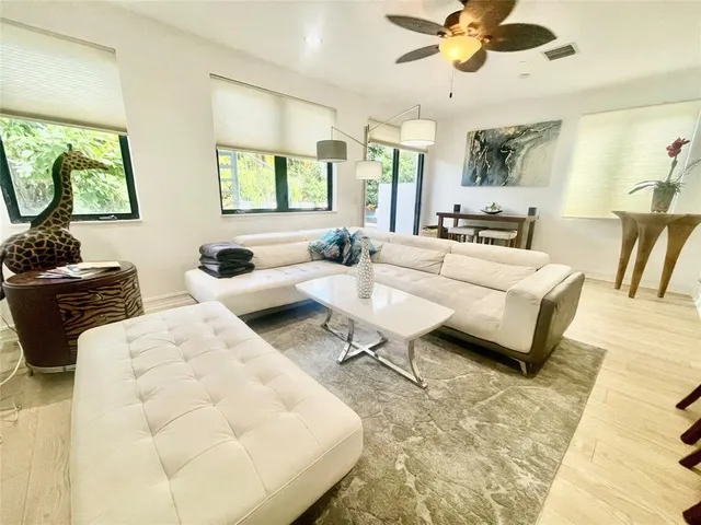 a living room with furniture a rug and white walls