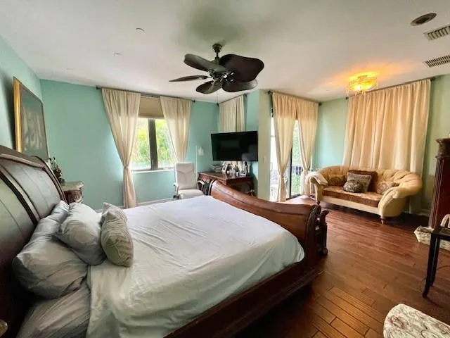 a bedroom with a bed and a large window