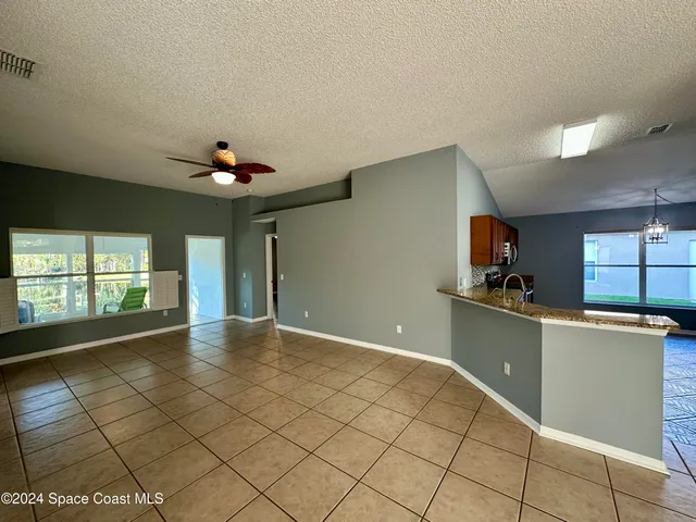 a view of a kitchen with kitchen appliances and a sink