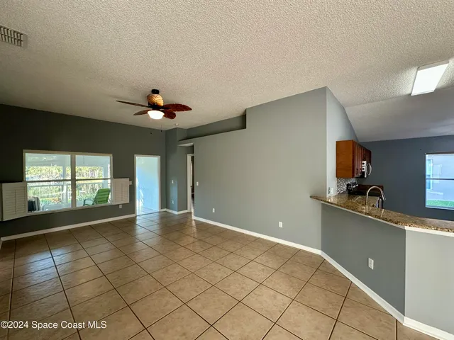 a view of a kitchen with a sink and a window