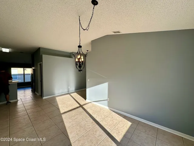 a view of a hallway with a chandelier