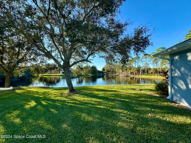 a swimming pool with outdoor seating and yard