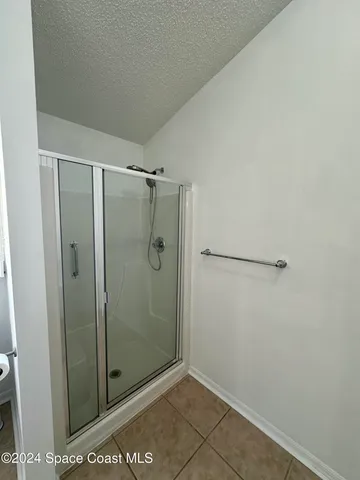 a bathroom with a glass shower door
