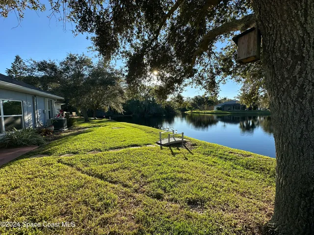 a view of a lake with a house in the background