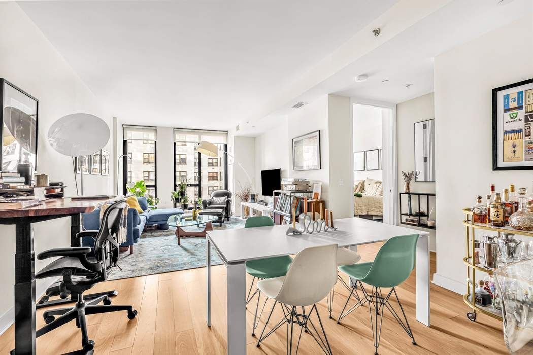 160 East 22nd Street, Unit 10D Manhattan, NY 10010 - Photo 2 of 12 a view of a dining room with furniture and chandelier