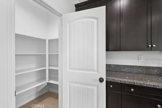 a kitchen with granite countertop cabinets and window