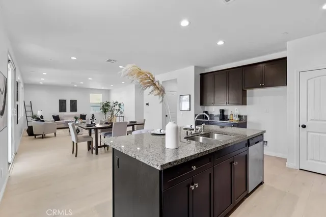 a kitchen with sink cabinets and living room